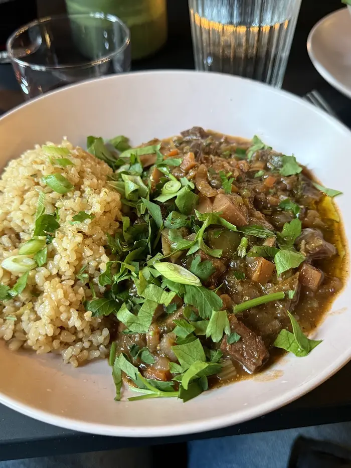Rich vegetable stew with herbs and brown rice