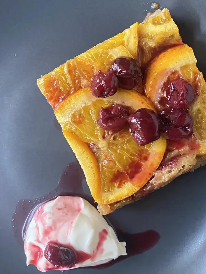 Orange and cherry upside-down cake with cream